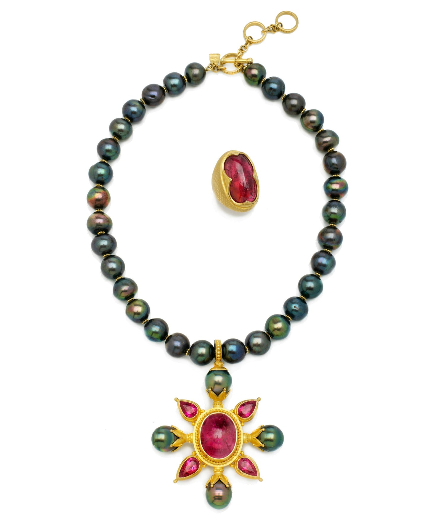 Pearl necklace with gold and gemstone pendants on a white background