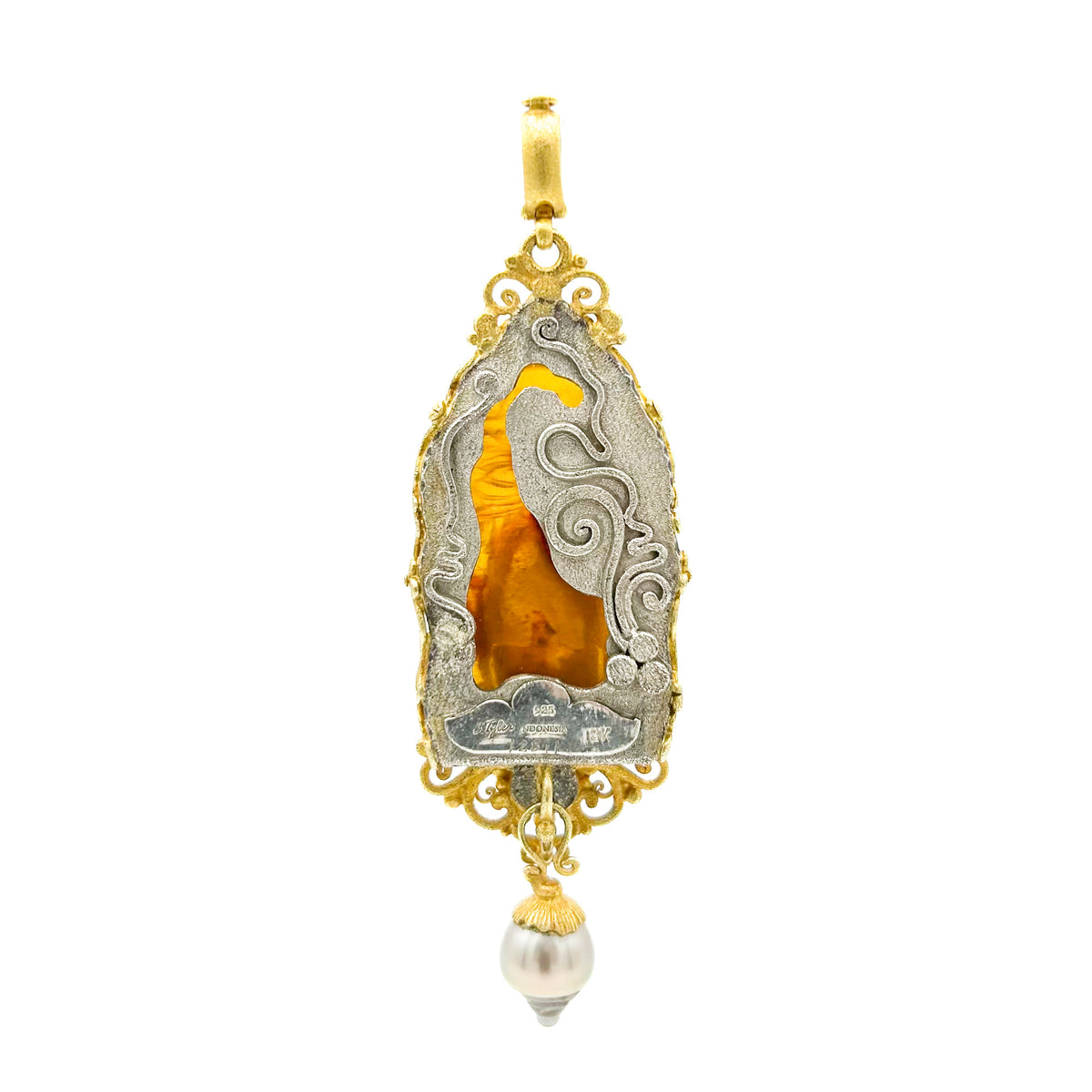 Decorative pendant with gold and silver design on a white background