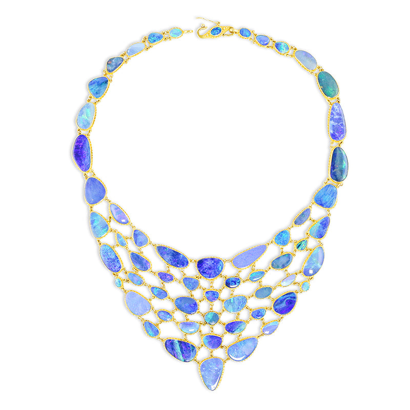 A bib-style necklace with a fluid mosaic design, featuring vibrant blue boulder opals set in 22k gold with intricate granulation around the bezel.