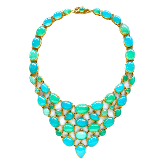 A bib-style necklace with a vibrant array of blue agate and green chrysoprase gemstones set in 22k gold, with a fluid mosaic design.