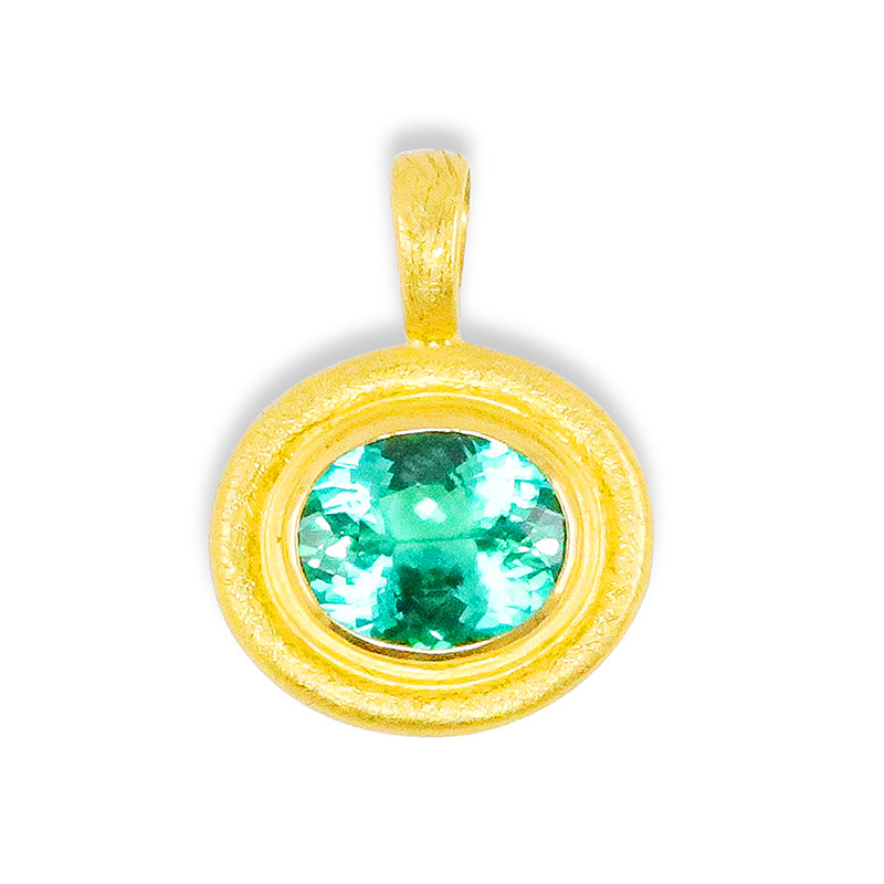 A lab-created emerald gemstone set in a 22k gold double-row bezel with a hammered finish.